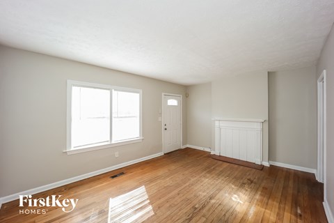 the living room and dining room of a house with wood floors