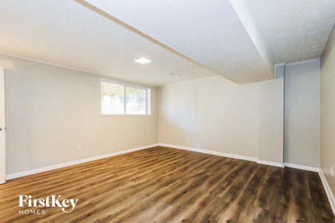 A room with wooden floors and a window.