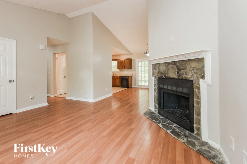 a living room with a fireplace and a wooden floor