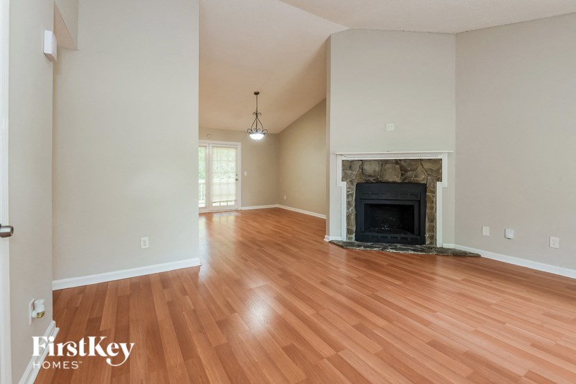 a living room with a fireplace and a wooden floor