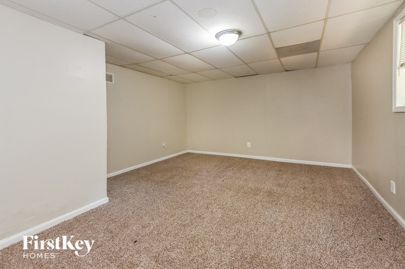 an empty room with a carpeted floor and white walls