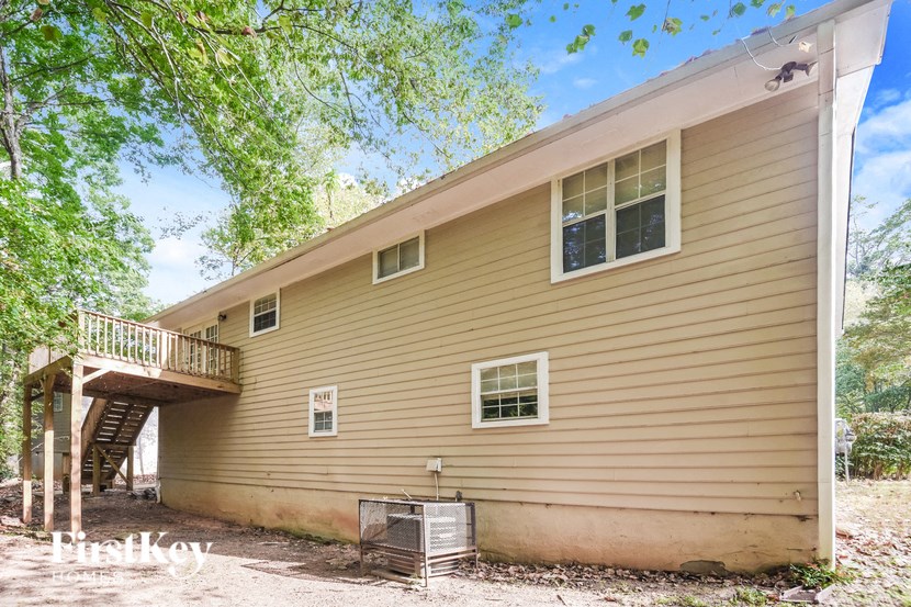 the back of a house with a deck and a staircase