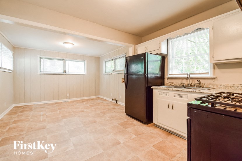 a kitchen with a refrigerator and a stove and a sink