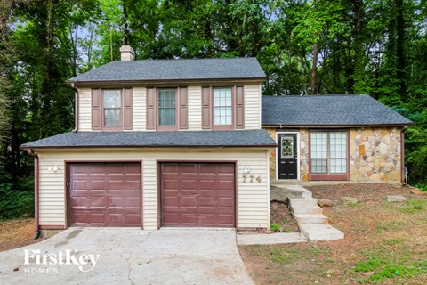 a small house with a garage and a driveway