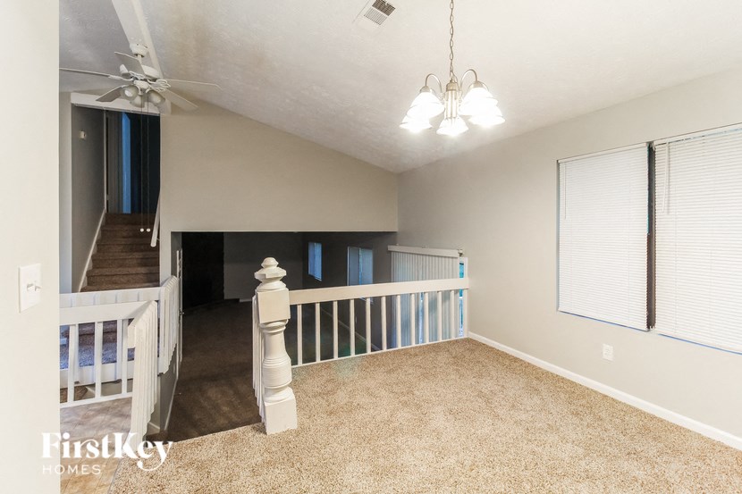 the loft has a staircase and carpeted flooring and a stairway to the