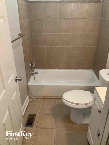 a bathroom with a toilet and a bath tub