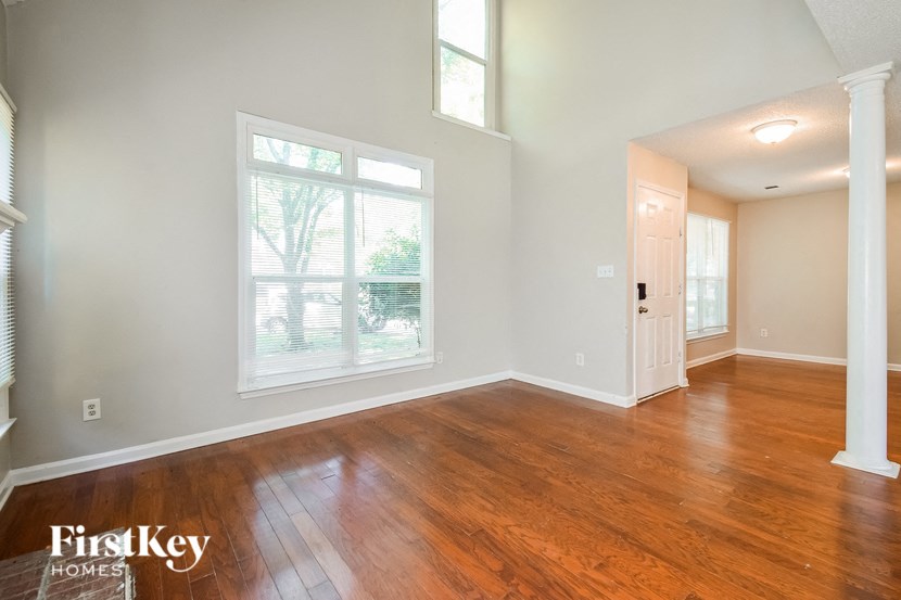 the living room and dining room with hardwood flooring