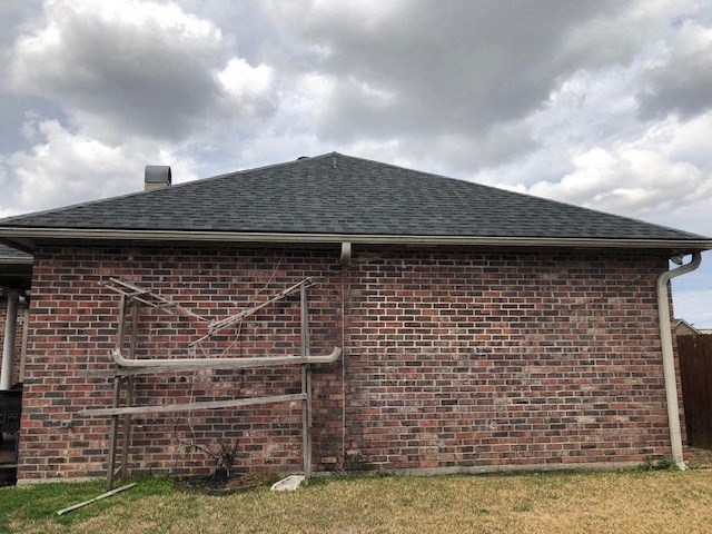a brick building with a pipe on the side of it