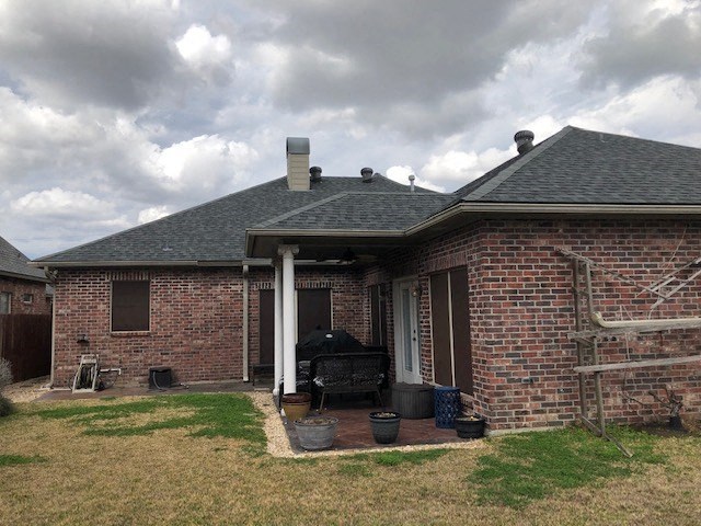 a brick house with a grill in the yard