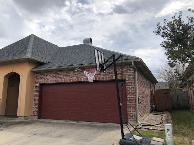 a basketball hoop on the side of a garage
