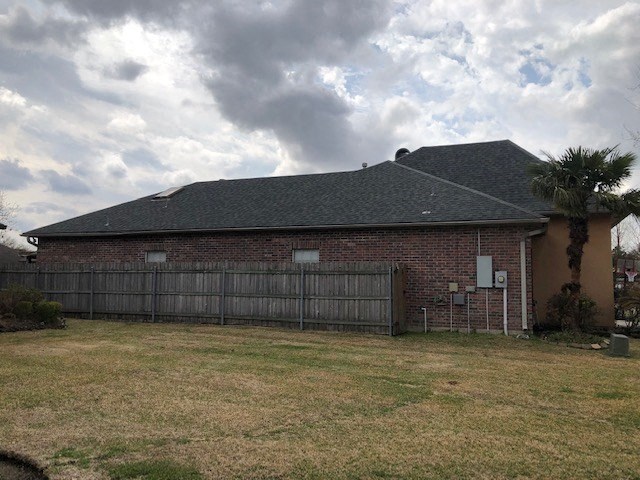 a brick house with a fence in front of it