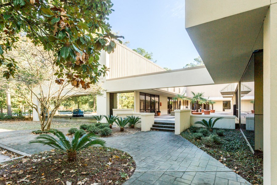 a house with a walkway and a garden