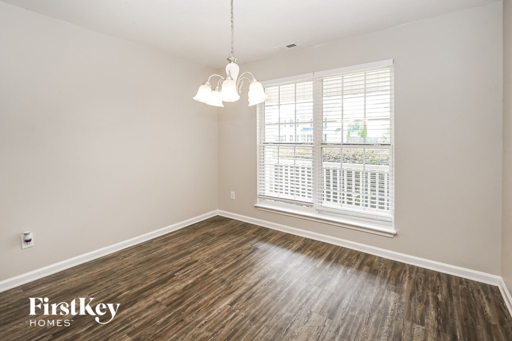 a living room with wood floors and a large window