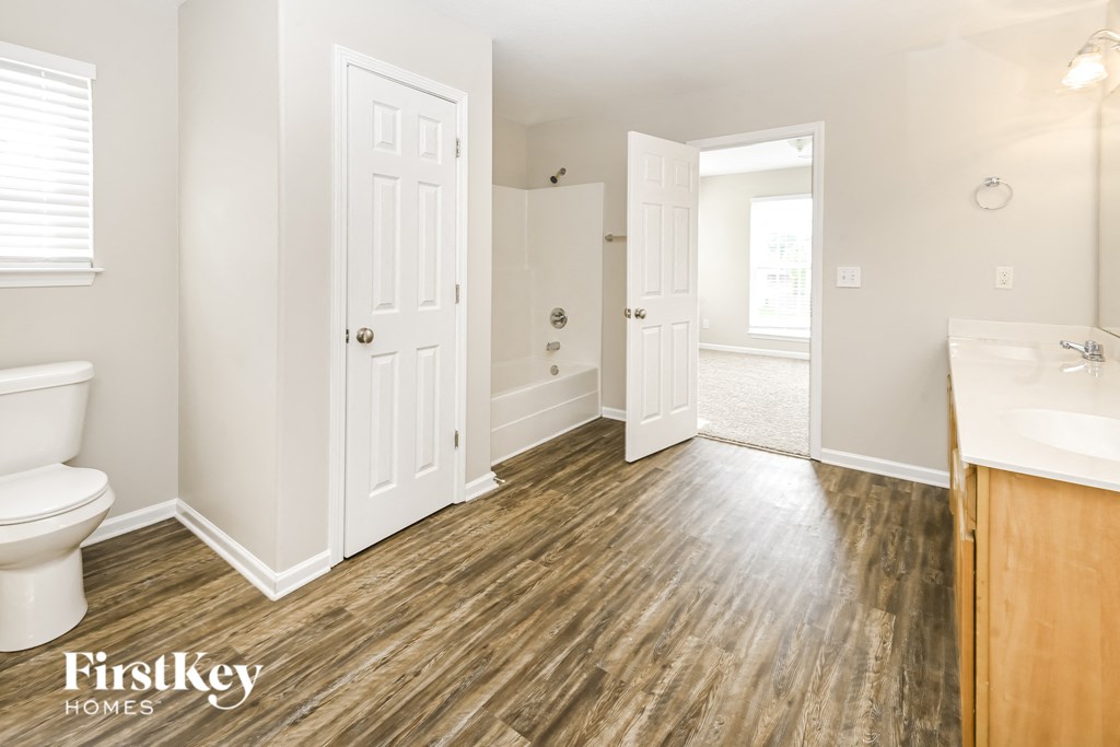 a bathroom with a toilet and a sink and a mirror