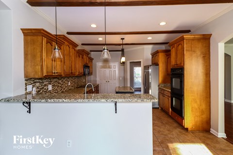 a kitchen with wooden cabinets and a granite counter top
