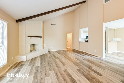 a living room with wood flooring and a fireplace
