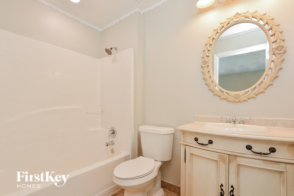 a bathroom with a sink toilet and a bath tub