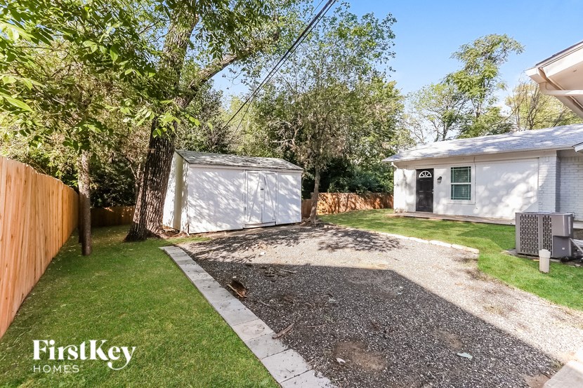 a small yard with a garage and a house