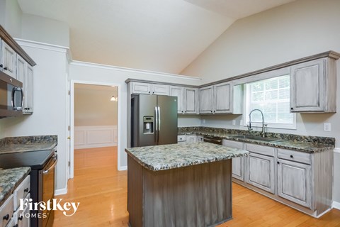 a kitchen with granite counter tops and stainless steel appliances