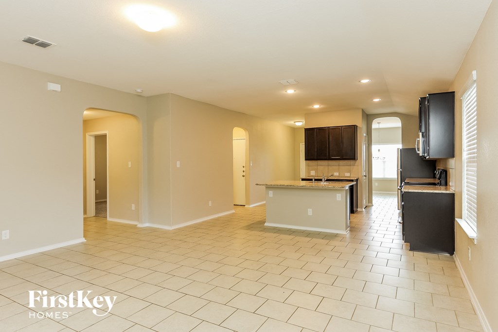 a kitchen and living room with tile flooring and a counter top