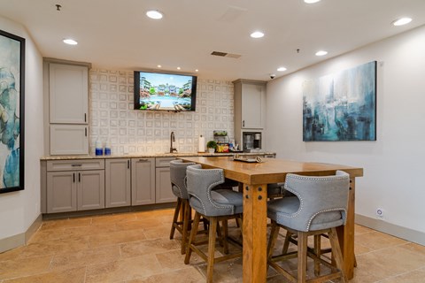 a kitchen with a wooden table and chairs