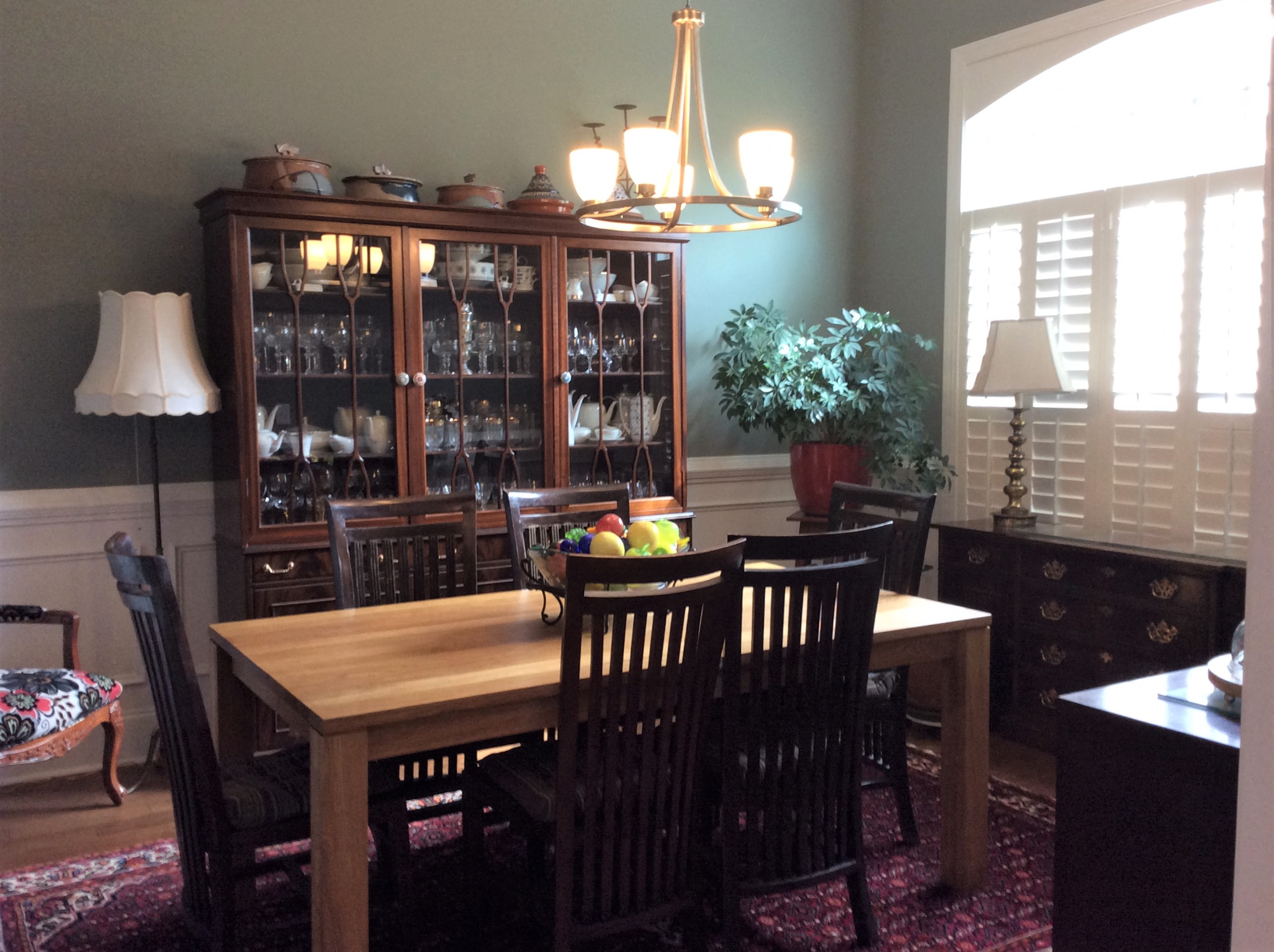 a dining room with a wooden table and a cabinet