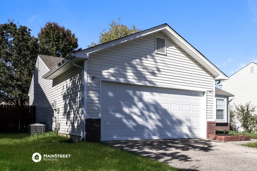 a white garage with a white door on the side of a house