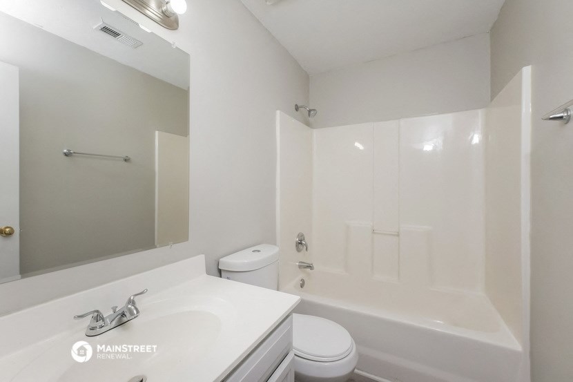 a bathroom with a sink and a toilet and a bath tub