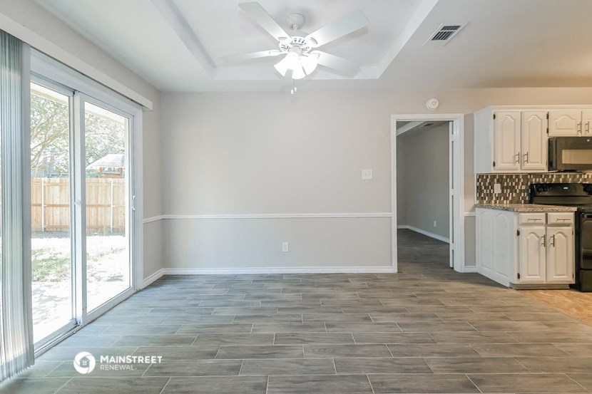 the living room and kitchen of a new home with a sliding glass door