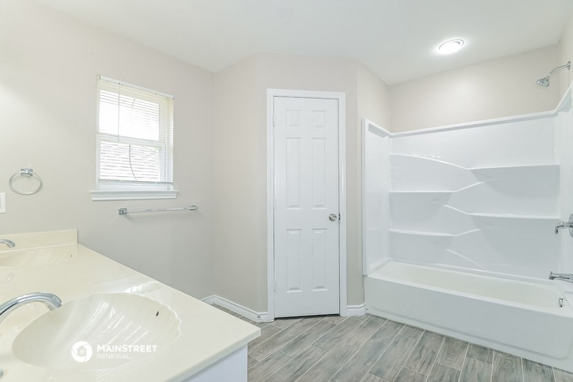a bathroom with a sink and a tub and a shower
