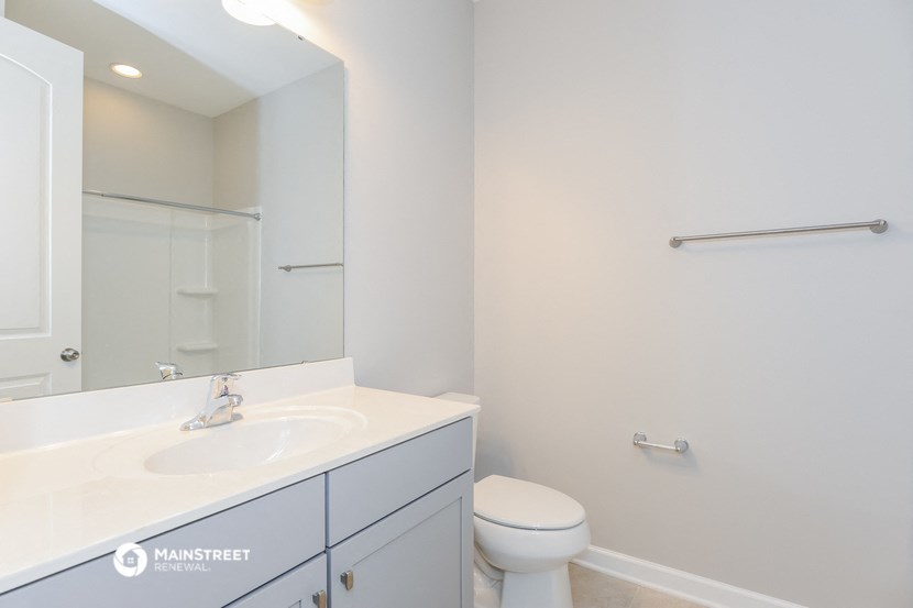 a bathroom with a sink and a mirror and a toilet