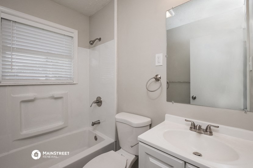 a white bathroom with a sink toilet and bath tub