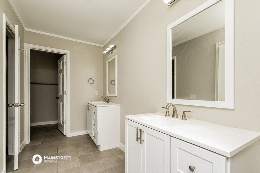 a white bathroom with a sink and a mirror