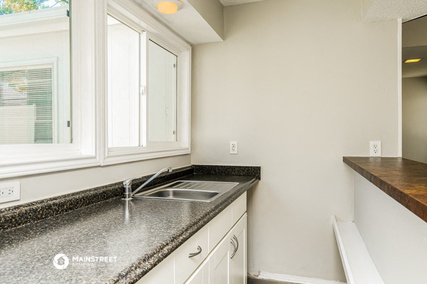 a kitchen with granite counter tops and a sink