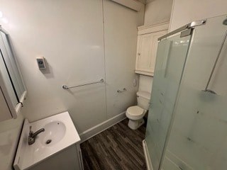A bathroom with a toilet, sink, and shower.