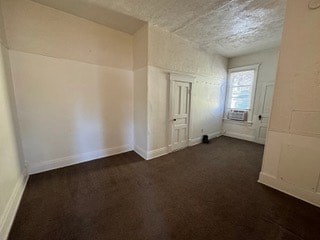 A room with brown carpet and white walls.