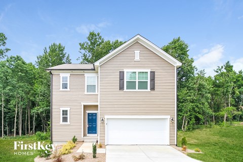 a tan house with a white garage door