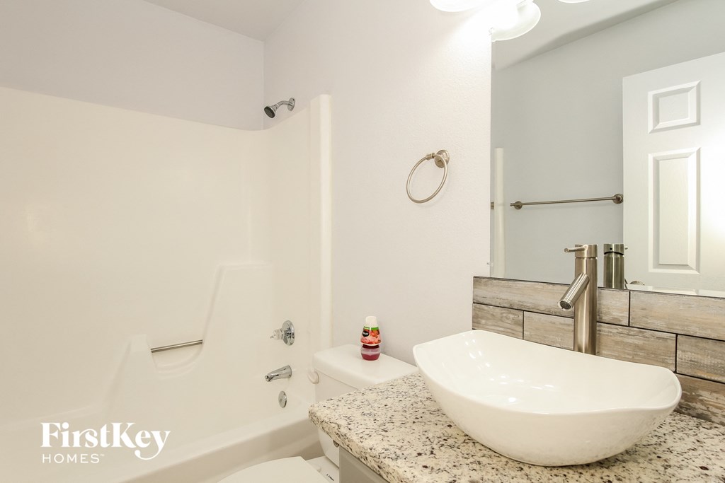 a bathroom with a sink and a toilet and a bath tub