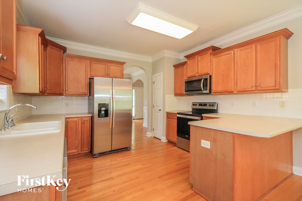 a kitchen with wooden cabinets and stainless steel appliances