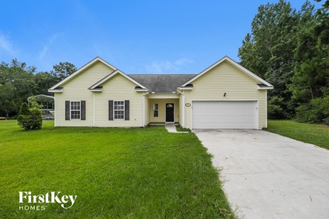 A two-story house with a garage is for sale.
