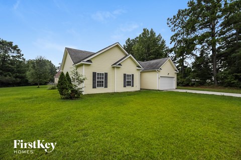 A house with a white garage door and a black roof.
