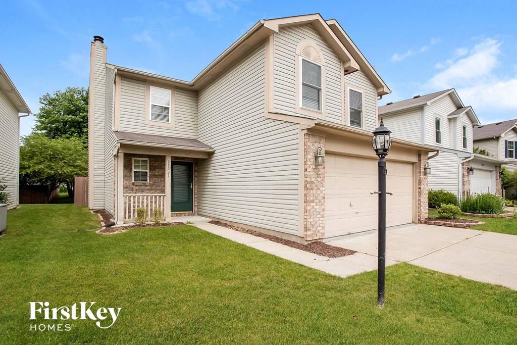 a white house with a street light in front of it