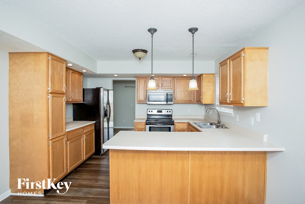 a kitchen with wooden cabinets and a white counter top