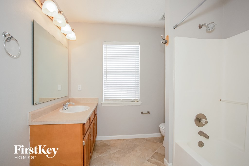 a bathroom with a sink and a shower and a toilet