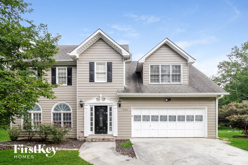 the front of a house with a white garage door