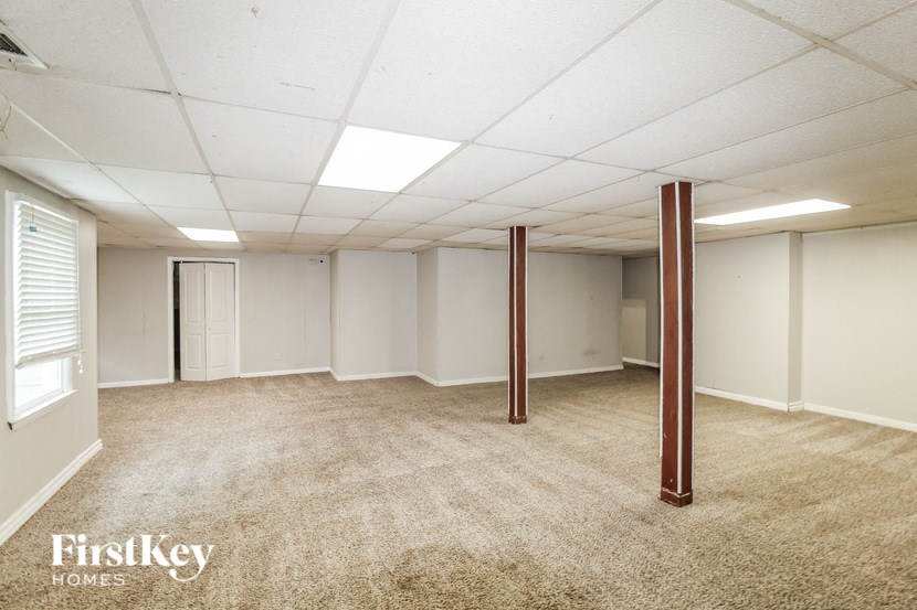 an empty room with white walls and a carpeted floor