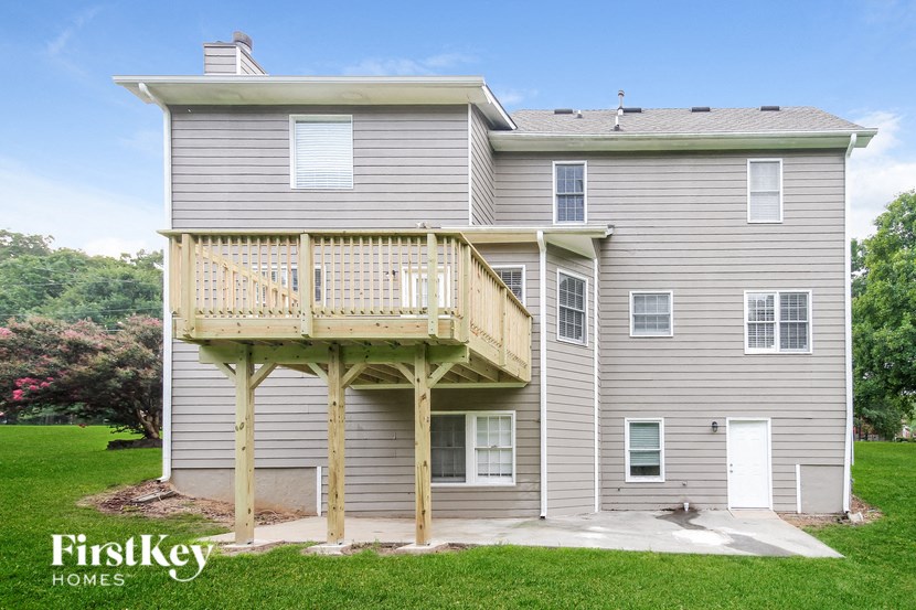 the back of a house with a wooden deck