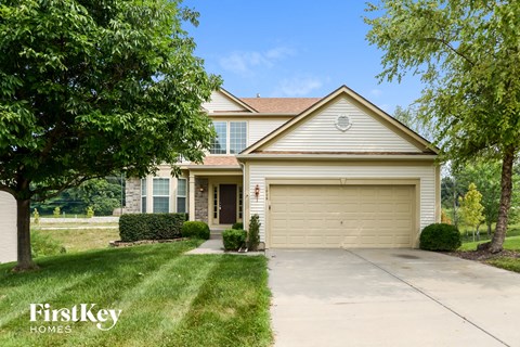 a home with a driveway and a garage door