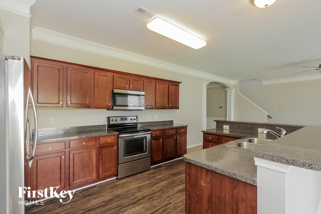 a kitchen with wooden cabinets and stainless steel appliances
