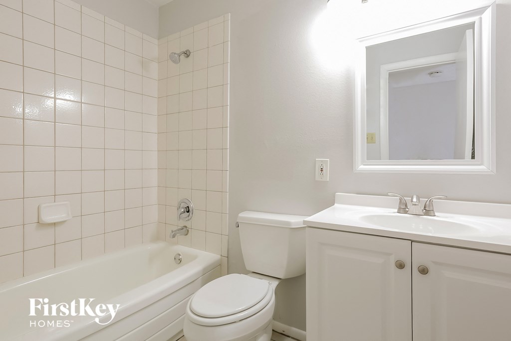 a white bathroom with a toilet sink and tub